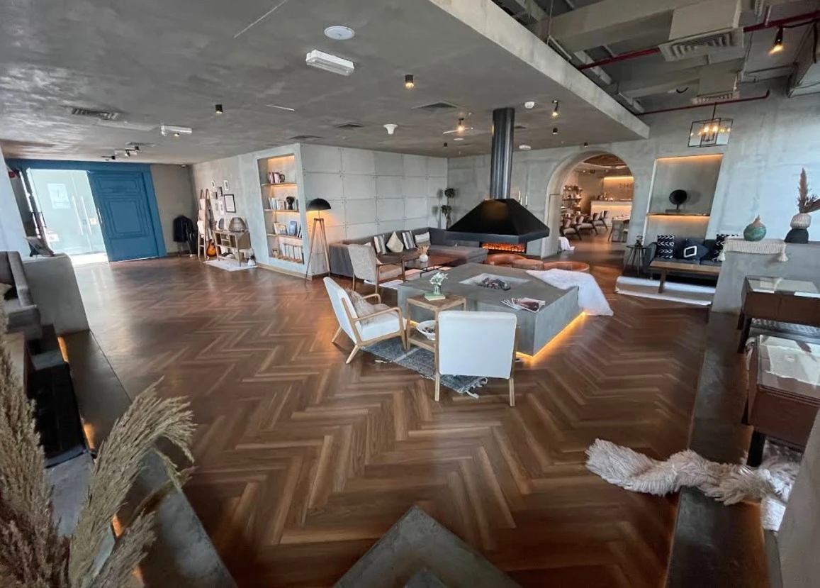Modern lounge area at The House Restaurant Lusail, with fireplace.