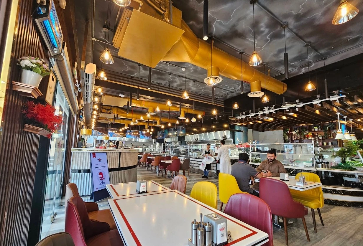 Interior of Grillo Restaurant Fanateer, Al Jubail, with colorful seating.