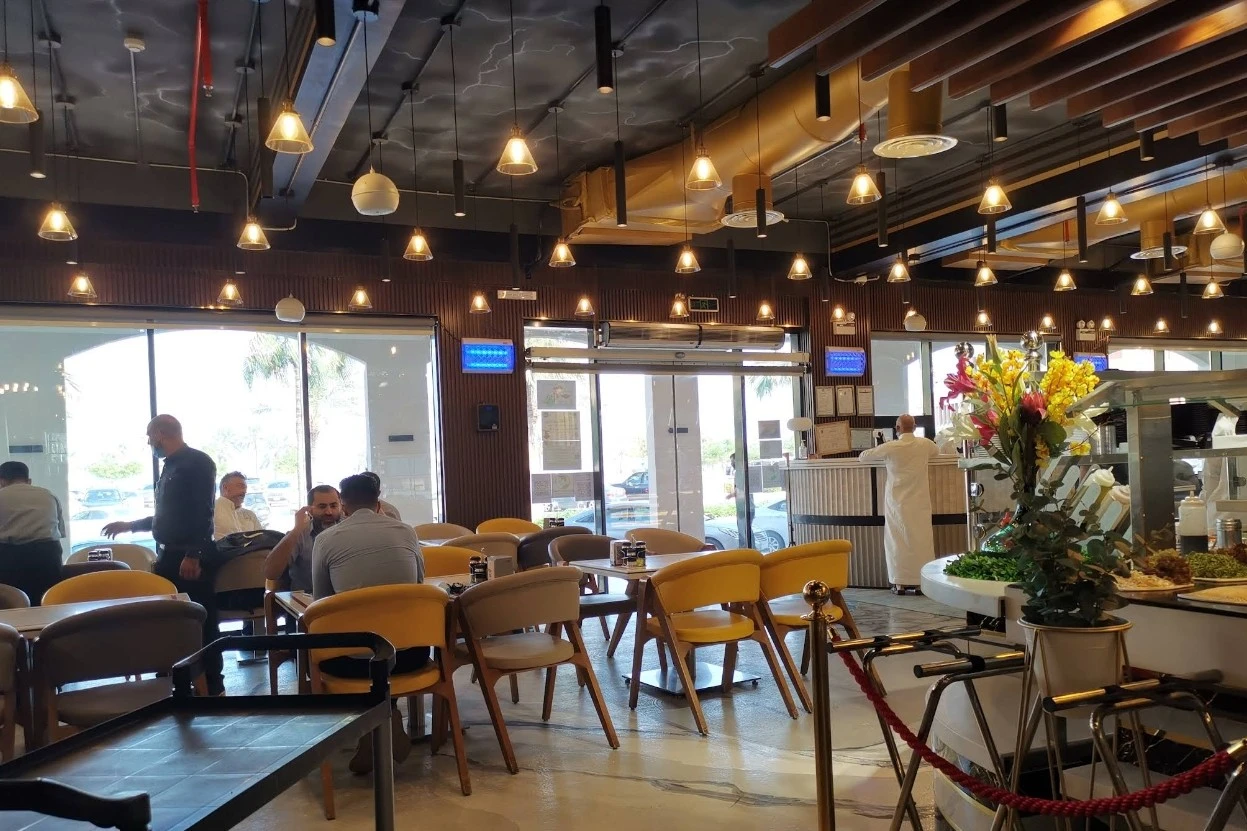 Grillo Restaurant Fanateer interior with diners, Al Jubail.