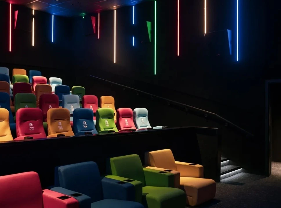 Colorful seating in VOX Cinemas Jubail, Al Jubail, with neon lights.