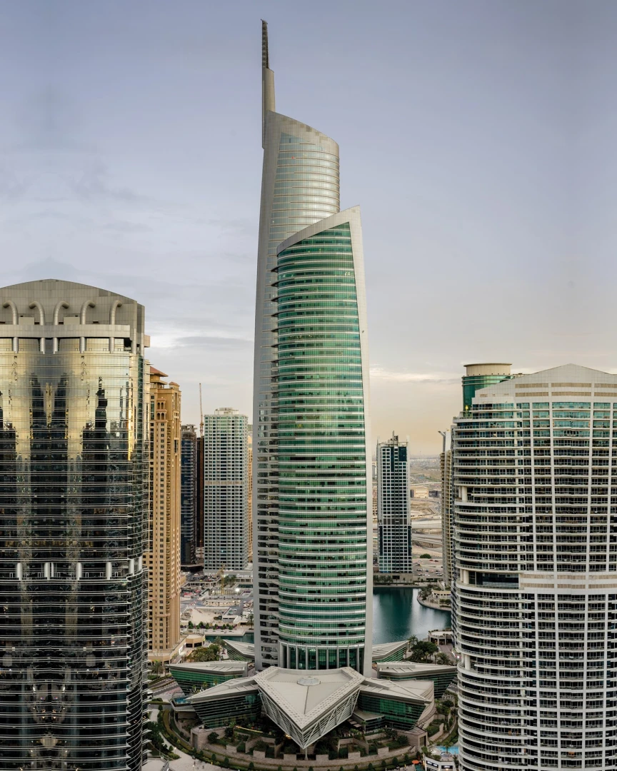 Almas Conference Centre skyscraper in Dubai, surrounded by modern buildings.