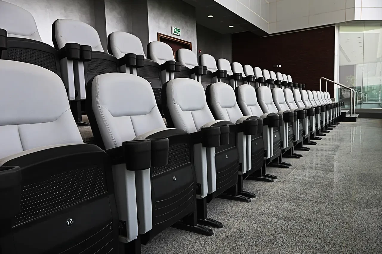 Abdullah Bin Khalifa Stadium seating area with gray chairs, Doha.