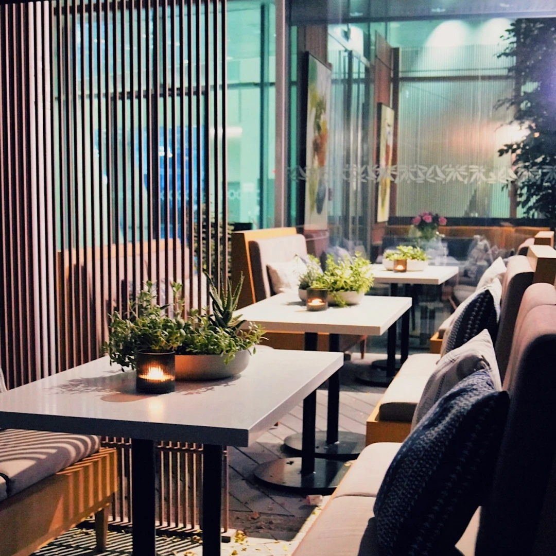 Cozy seating with plants at Twisted Olive & Naama’s Garden, Doha.