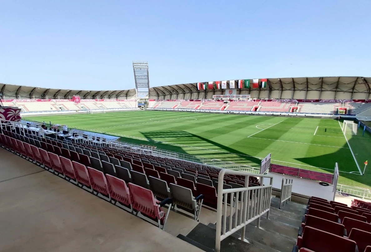 Abdullah Bin Khalifa Stadium, empty seats, green field, Doha.