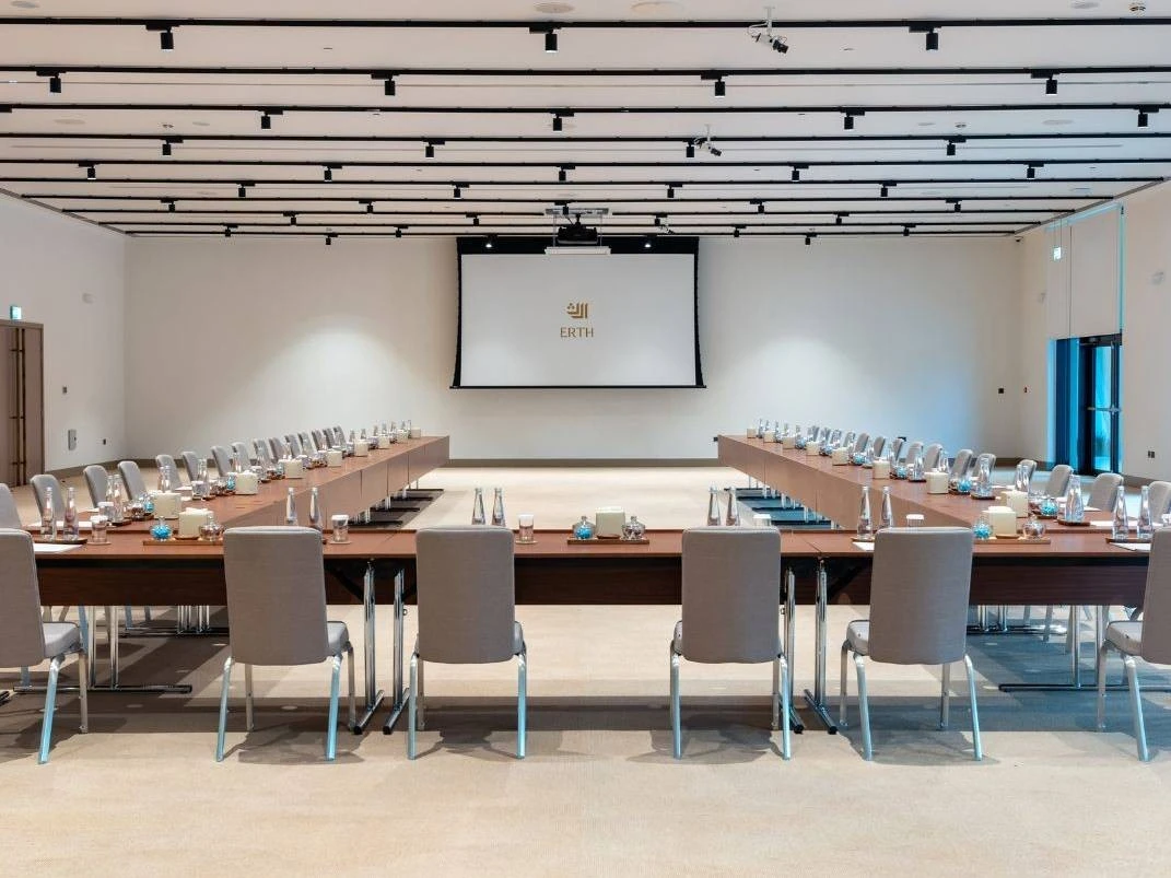 Conference room setup at Erth Hotel Abu Dhabi, U-shaped table arrangement.