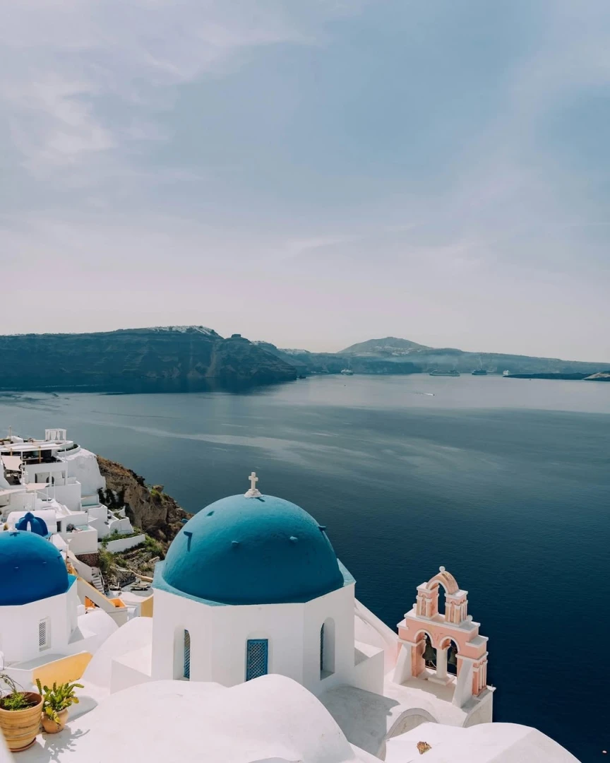 Santorini's iconic blue domes overlooking the Aegean Sea.