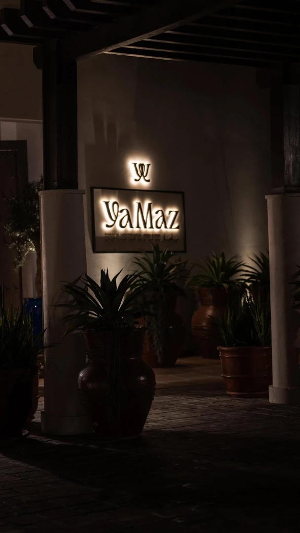 Yamaz Restaurant entrance with illuminated sign, Manama, Bahrain