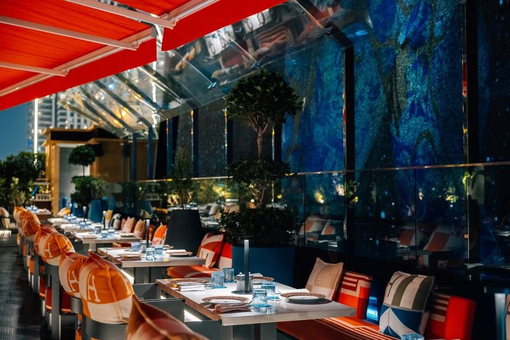 Elegant outdoor dining at Zenon Restaurant Dubai with colorful seating.