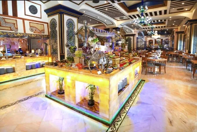 Elegant interior of Tuheed Pakistani Restaurant, Makkah with decorative buffet display.