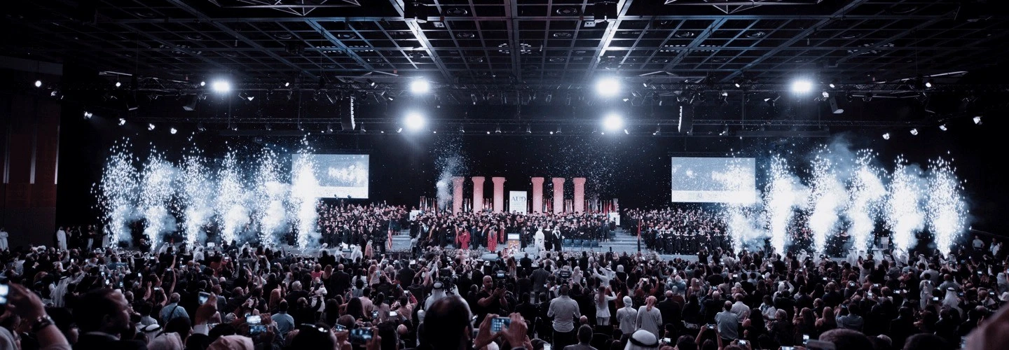 Crowded event with fireworks at Sheikh Rashid Hall, Dubai.