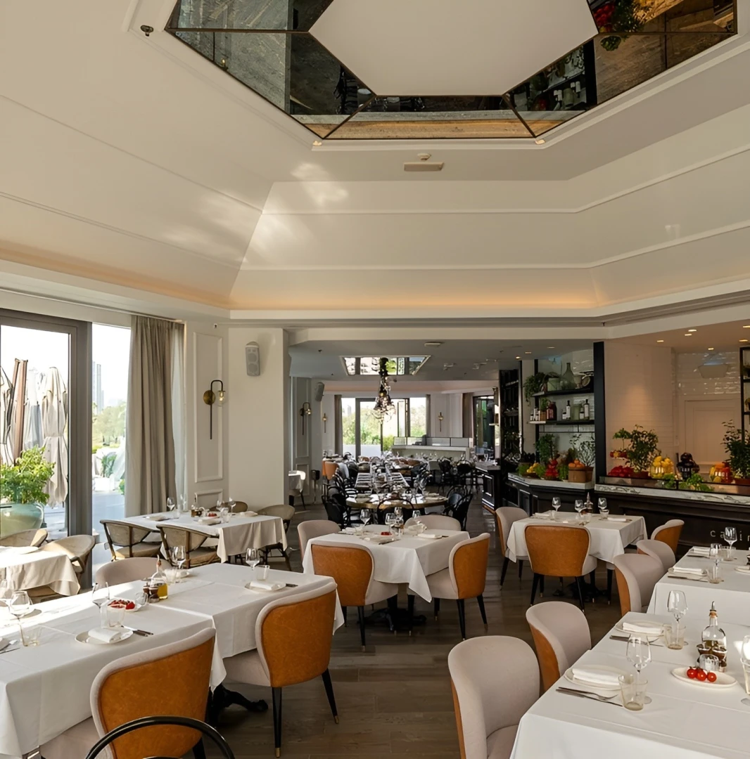 Elegant dining area at Carine Restaurant Dubai with white tablecloths.
