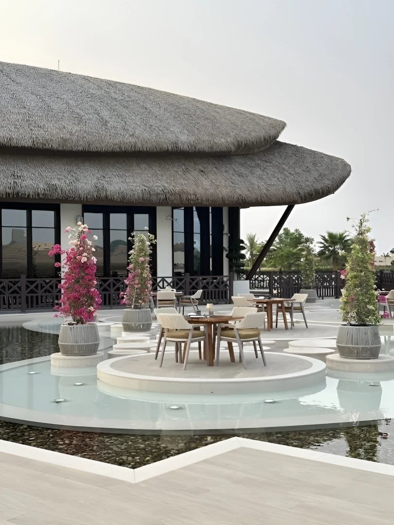 Outdoor seating at Mekong Restaurant, Ras Al Khaimah, with water features.