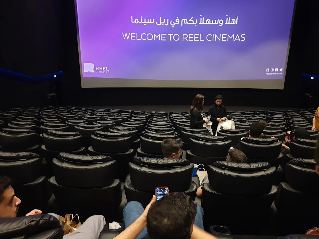Reel Cinemas auditorium with seated audience, Dubai Marina Mall.