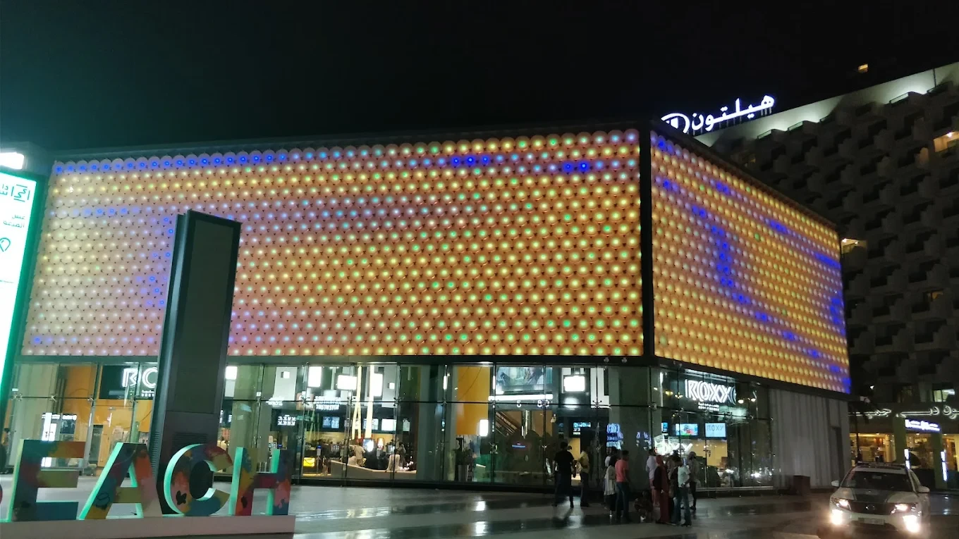 Reel Cinemas at Dubai Marina Mall illuminated at night.