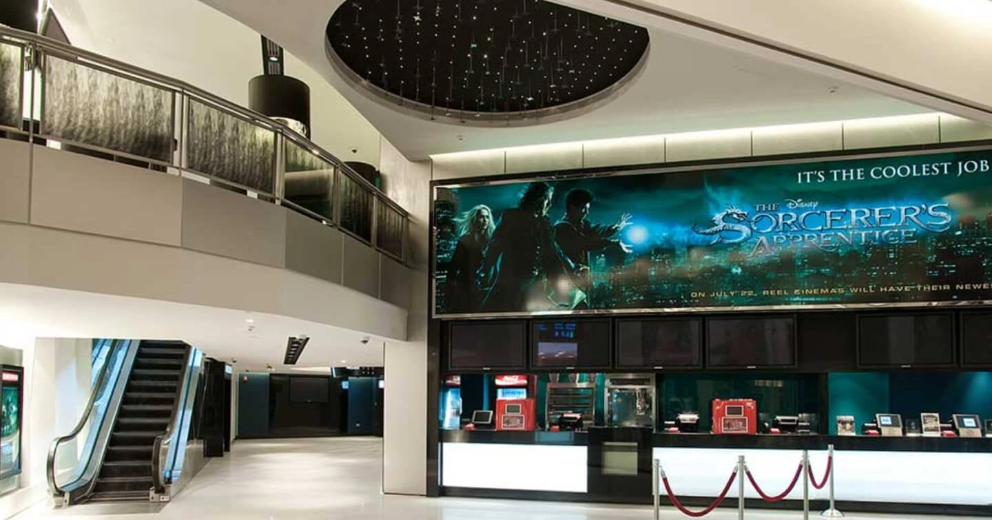 Lobby of Reel Cinemas, Dubai Marina Mall with movie poster.