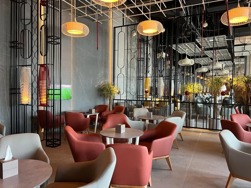 Modern interior of The Kana Cafe Downtown Dubai with colorful seating.
