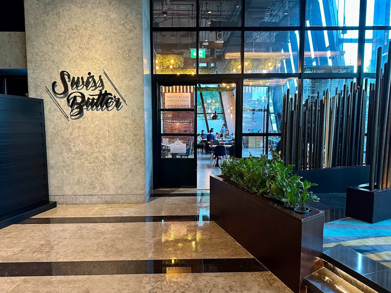 Entrance of Swiss Butter Steak House Downtown Dubai with modern decor.