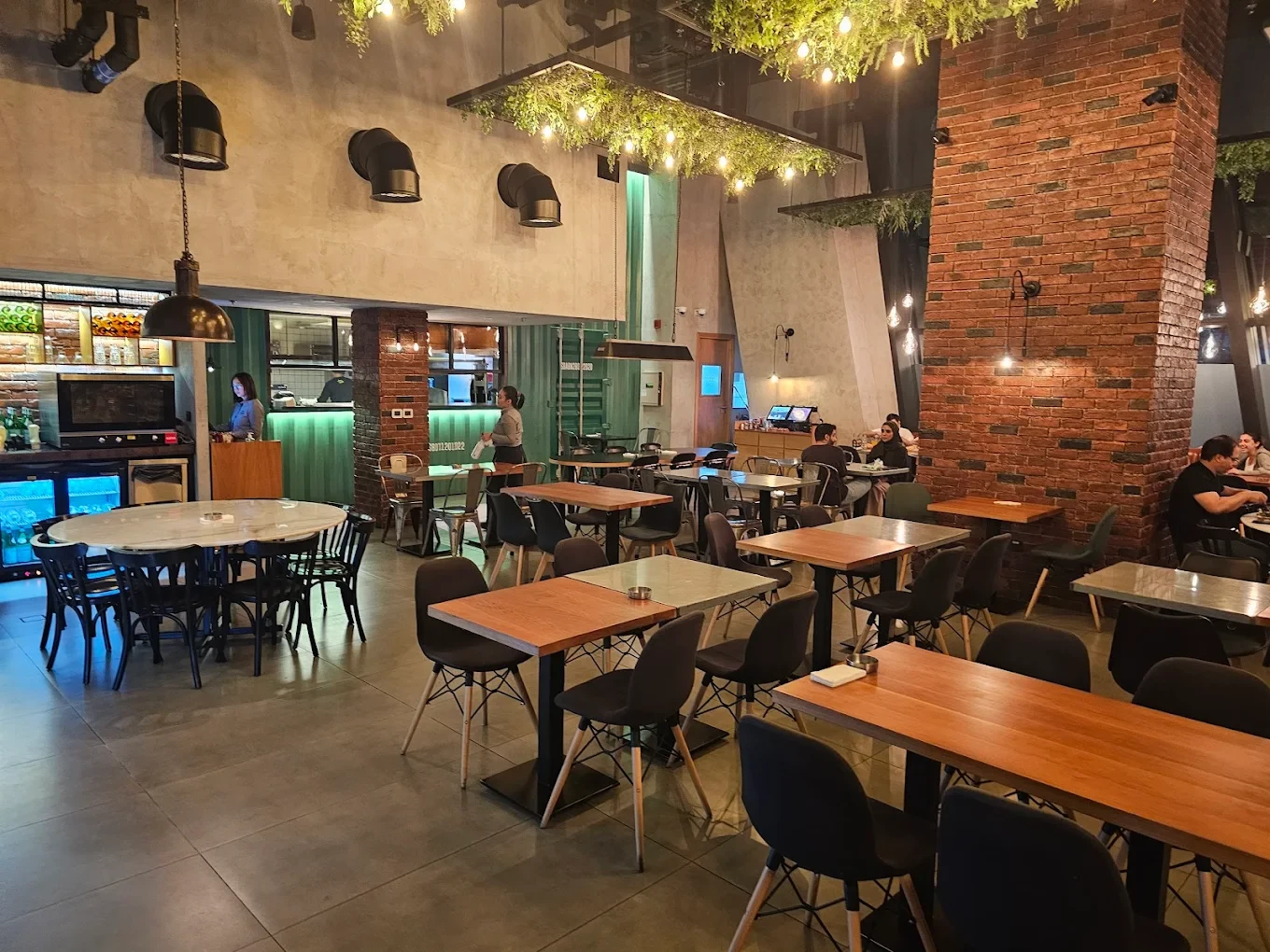 Swiss Butter Steak House interior with tables and brick wall, Dubai.