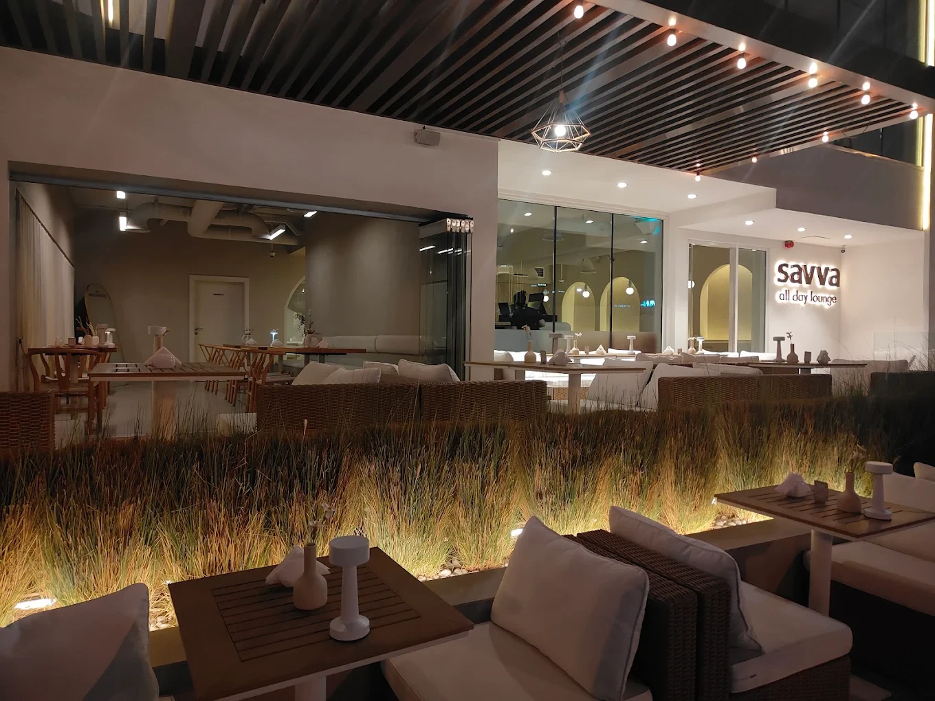 Savva All Day Lounge outdoor seating area in Dubai at night.