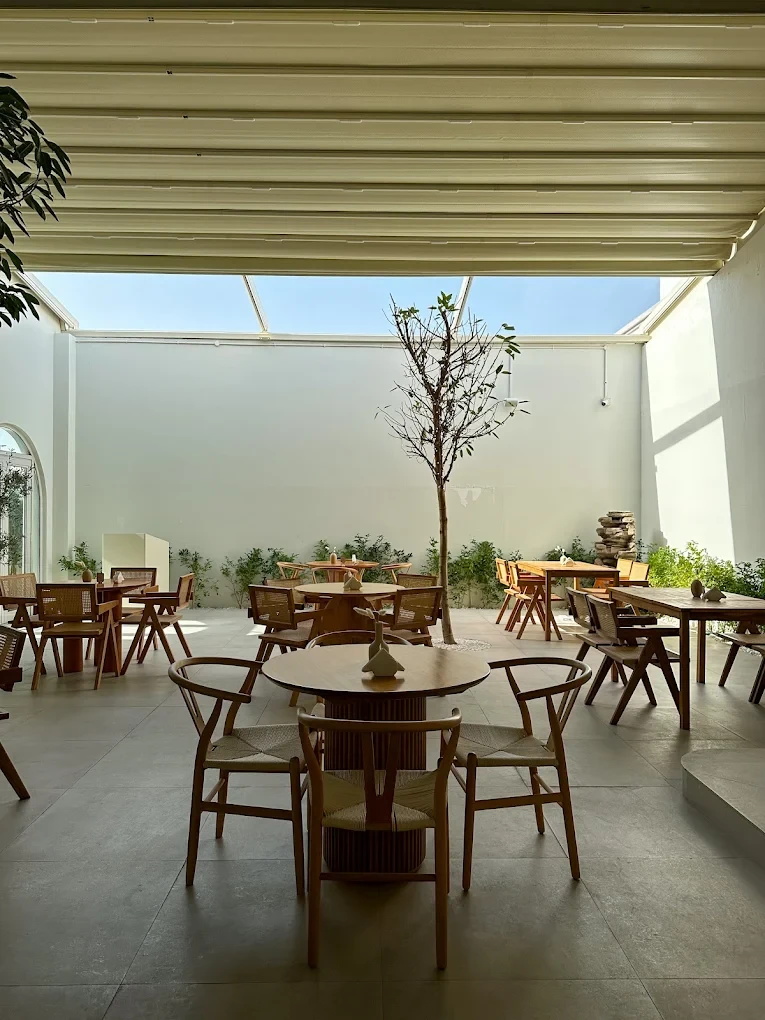 Savva All Day Lounge interior with wooden tables, Dubai.