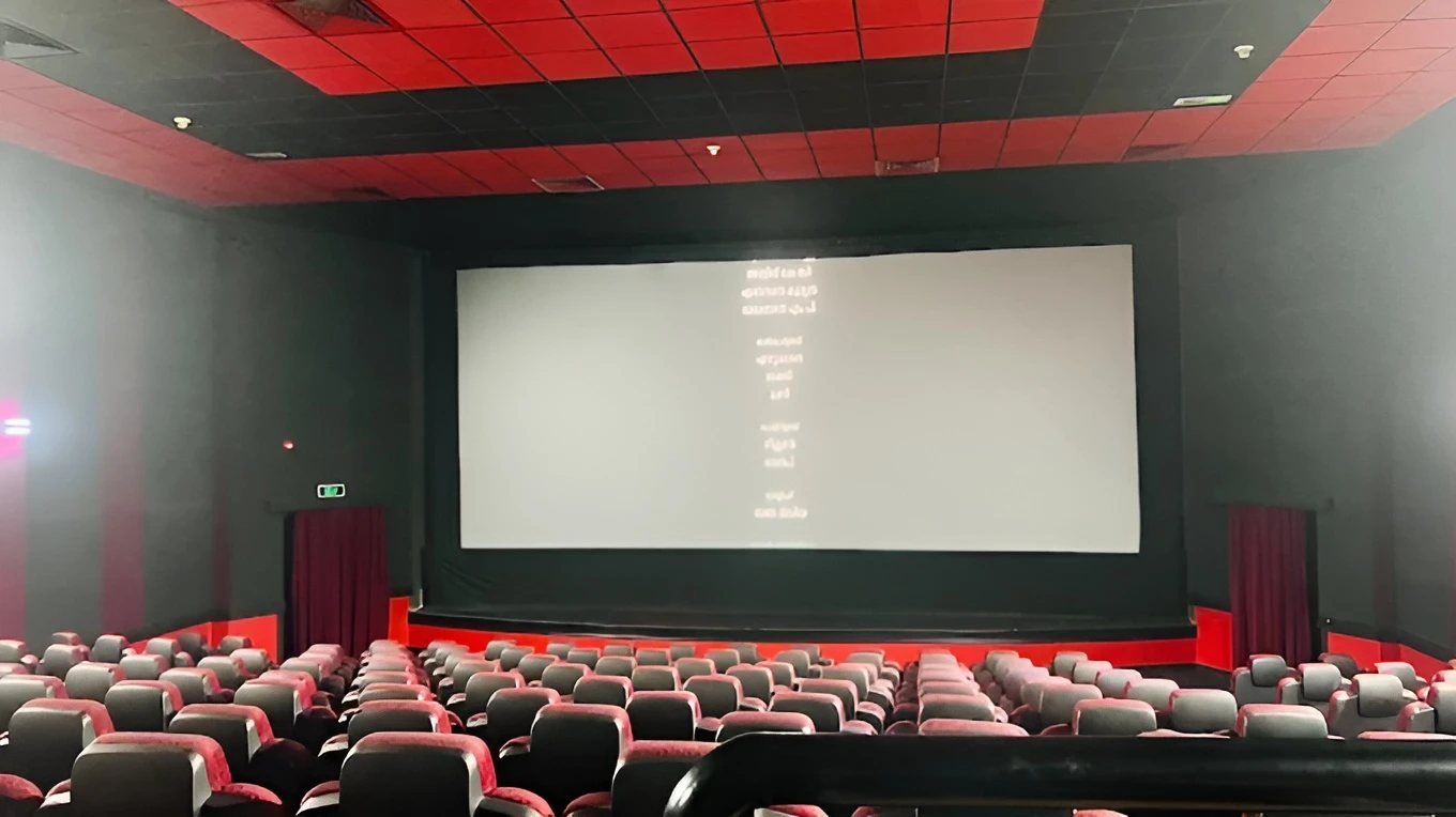 Empty theater at Gulf Cinema Ras Al Khaimah, red seats, large screen.