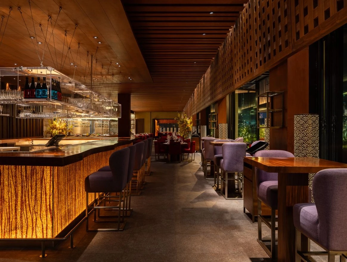 Elegant bar and lounge at Zuma Restaurant Doha, featuring modern decor.