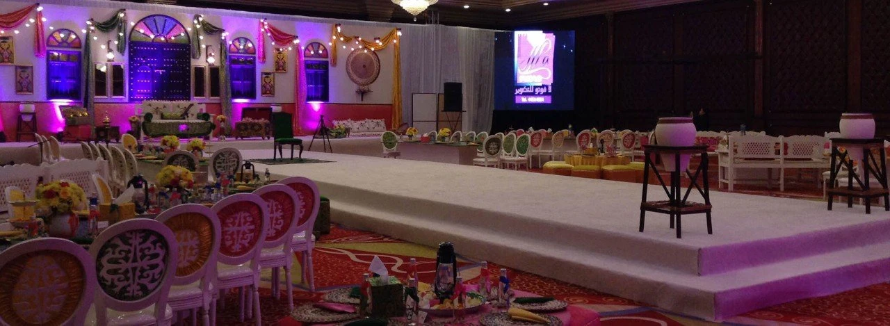 Regency Hall Doha decorated for an elegant event with stage and seating.