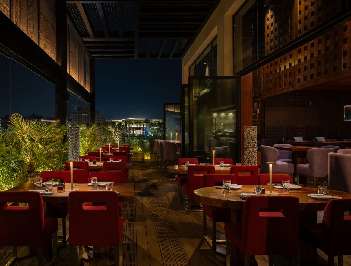 Elegant terrace dining at Zuma Restaurant Doha, night view.