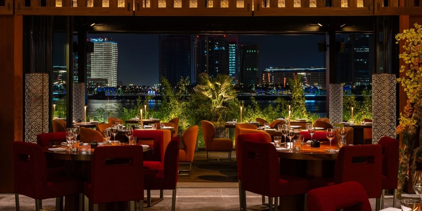 Elegant dining area at Zuma Restaurant Doha with city skyline view.
