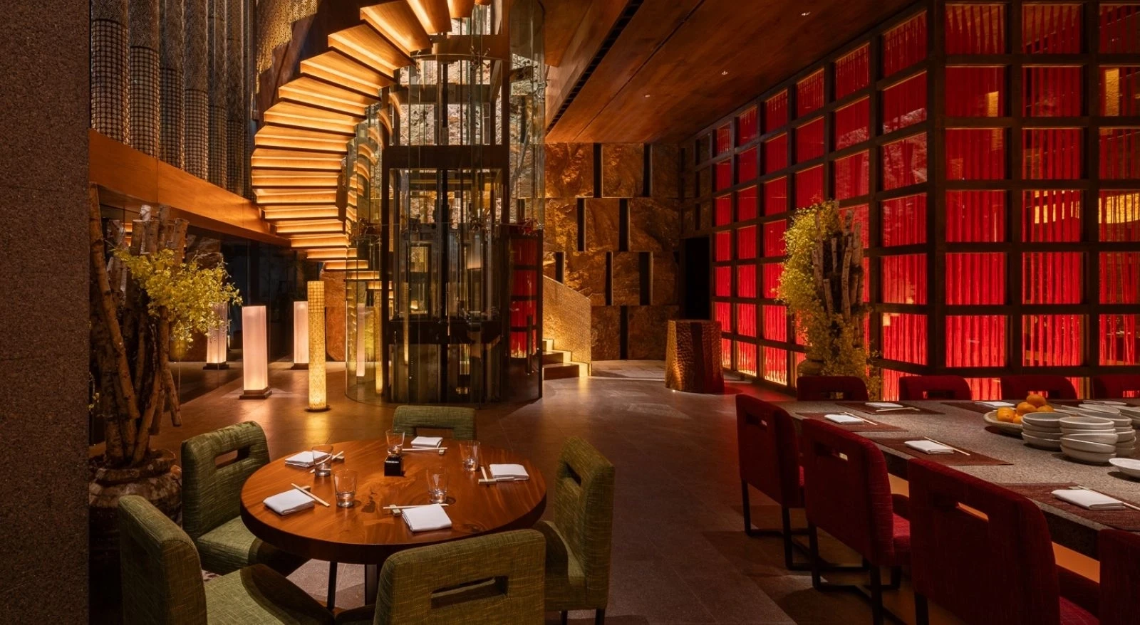 Elegant interior of Zuma Restaurant Doha with wooden and red accents.