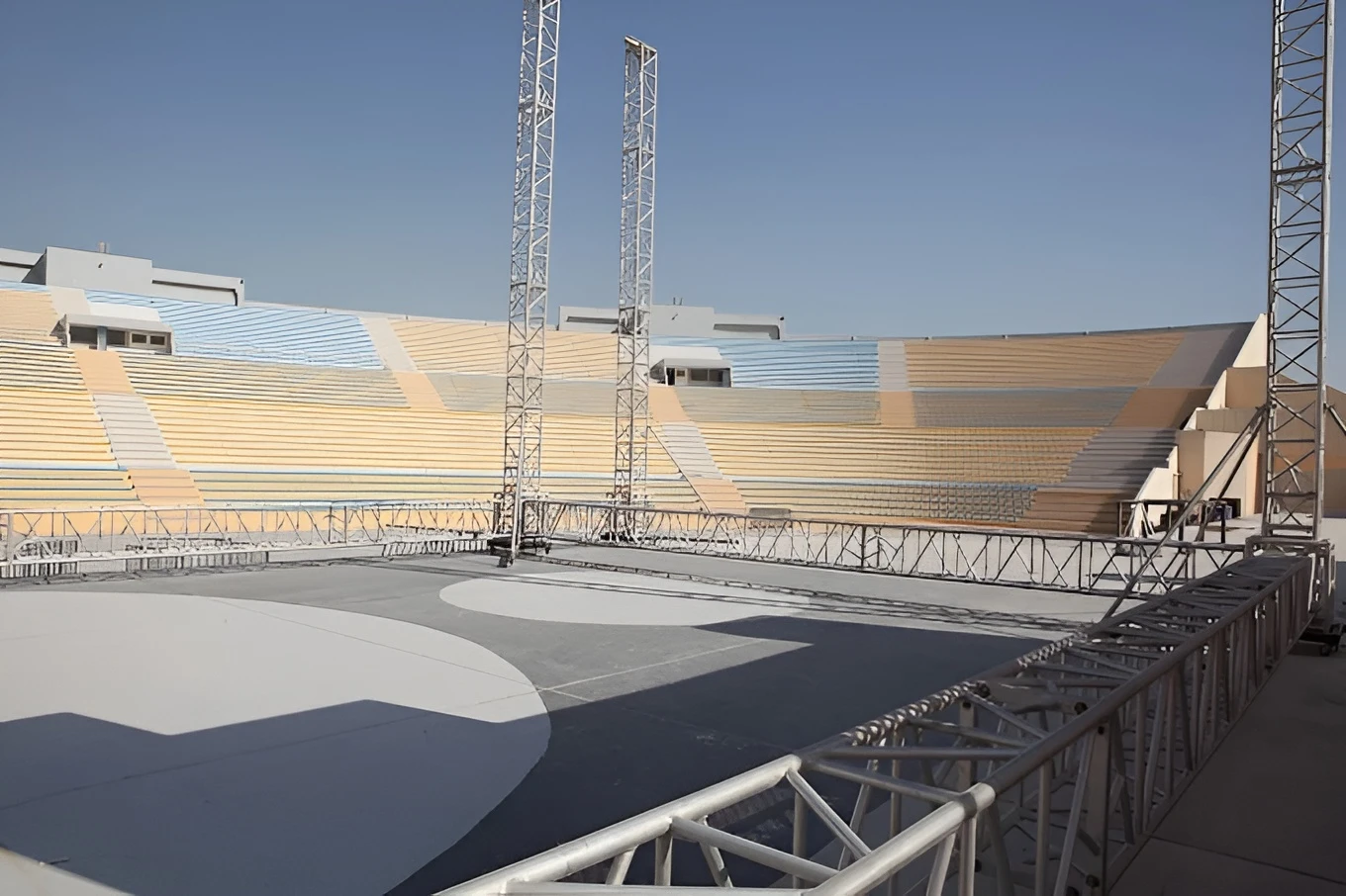 Empty Asian Town Amphitheater in Doha under clear blue sky.