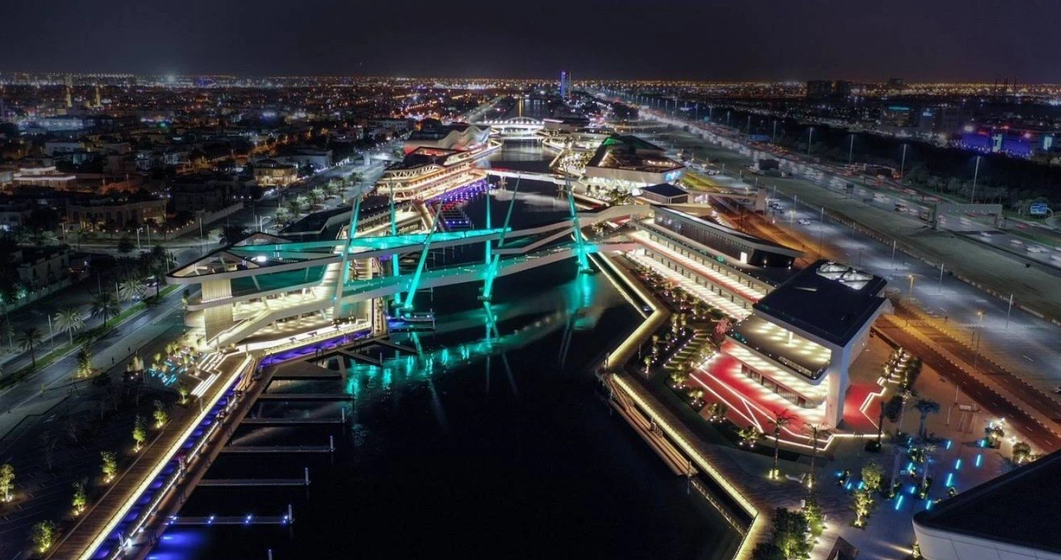 Al Qana Abu Dhabi illuminated waterfront at night.
