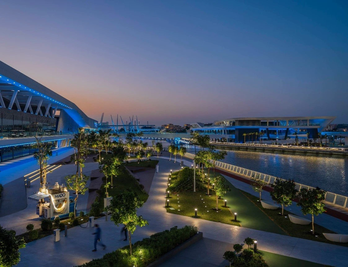 Al Qana waterfront at dusk, Abu Dhabi, with illuminated pathways.