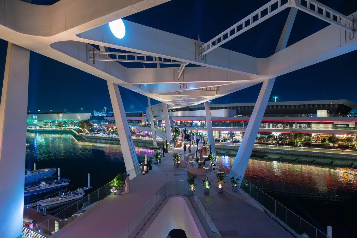 Night view of Al Qana walkway bridge, Abu Dhabi, with lights.