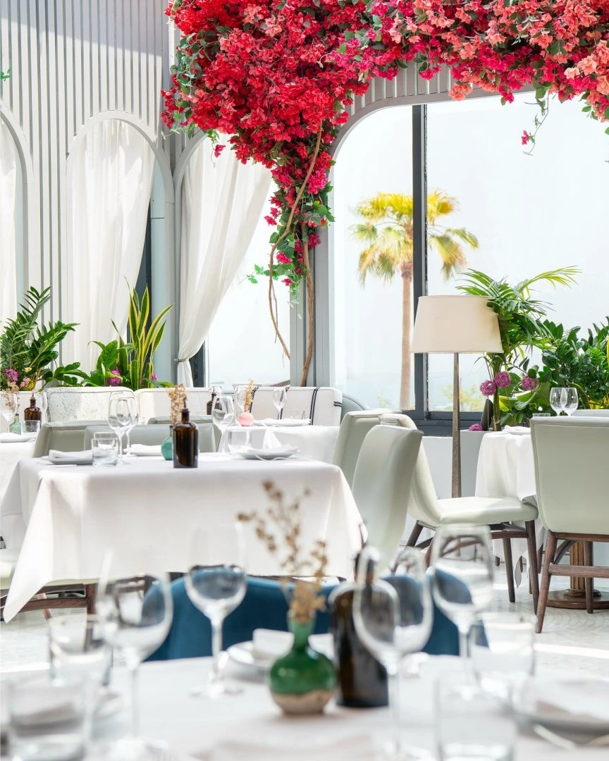 Elegant dining area with floral decor at Gaia Restaurant Doha.