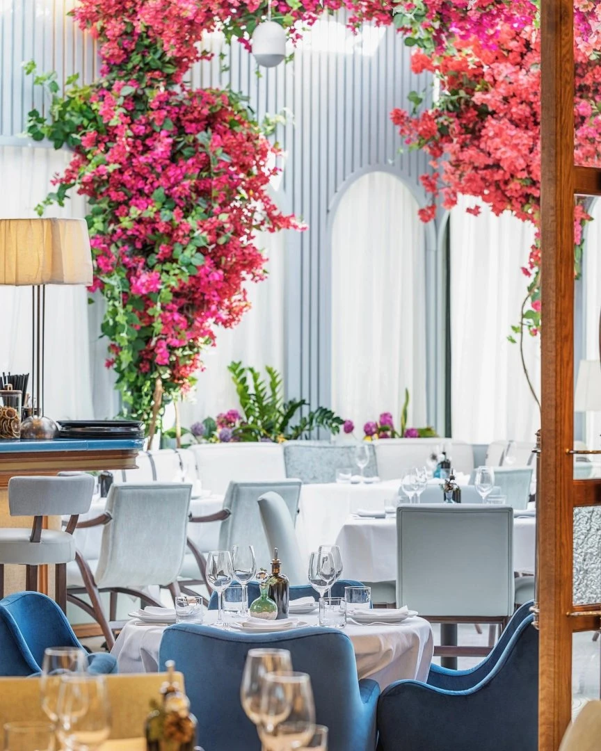 Elegant dining area with pink flowers at Gaia Restaurant Doha.
