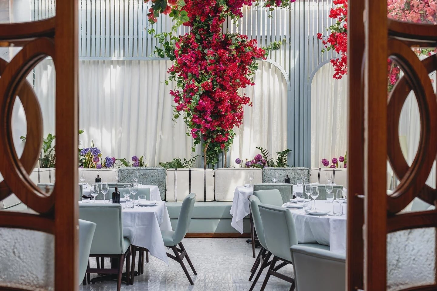 Elegant dining area with flowers at Gaia Restaurant Doha.