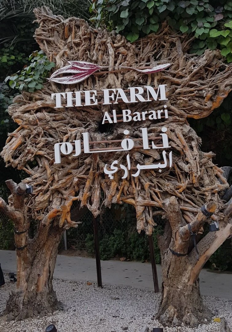 Decorative wooden sign at The Farm Restaurant, Al Barari, Dubai.