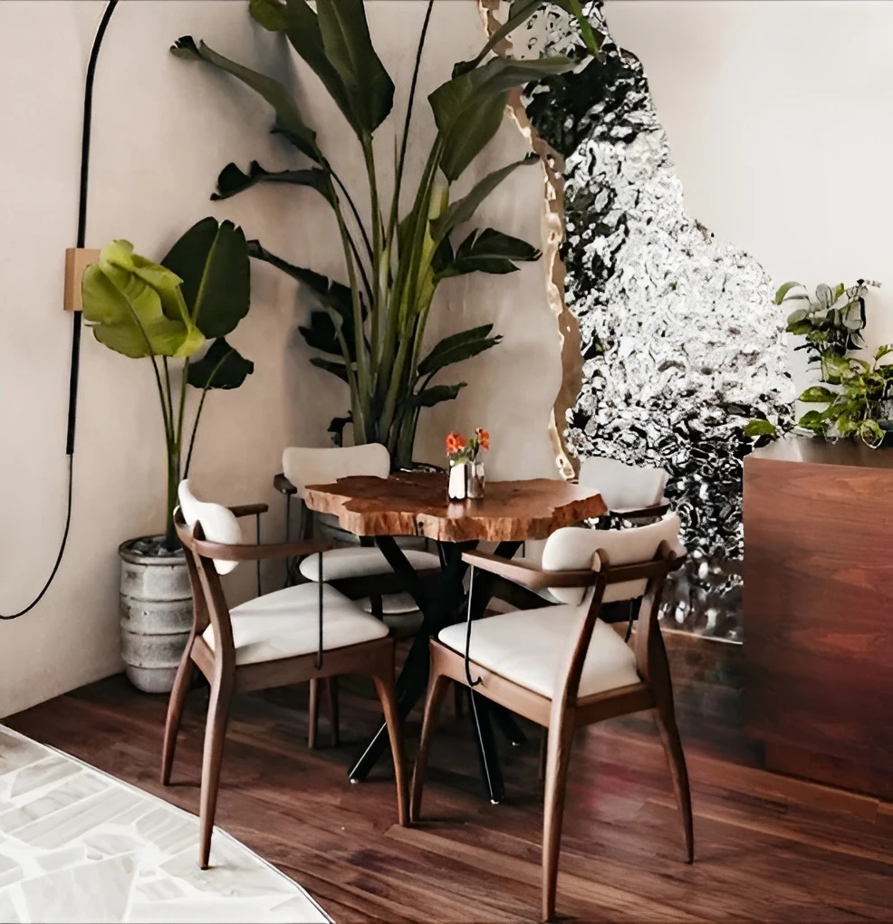 Elegant seating area at Era Restaurant Doha with lush plants.