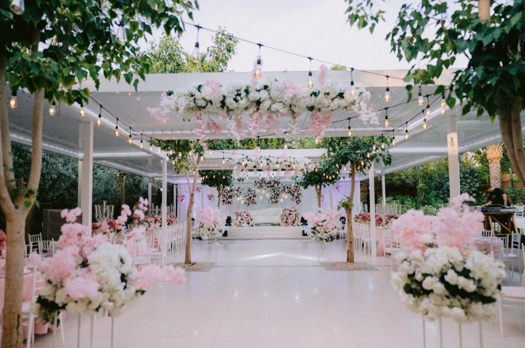 Floral-decorated garden venue with string lights, The Farm, Dubai.