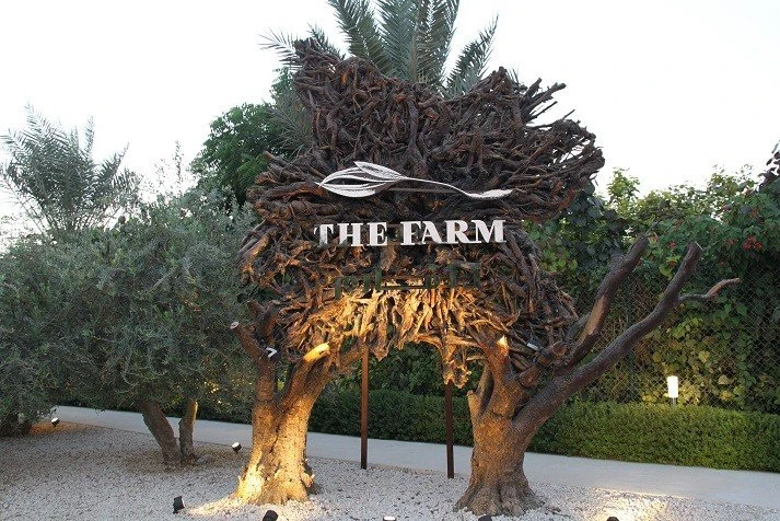 The Farm Restaurant entrance with artistic tree sculpture, Al Barari, Dubai.