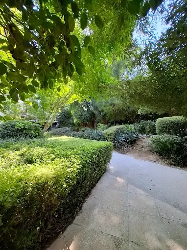 Lush garden path at The Farm Restaurant Al Barari, Dubai.