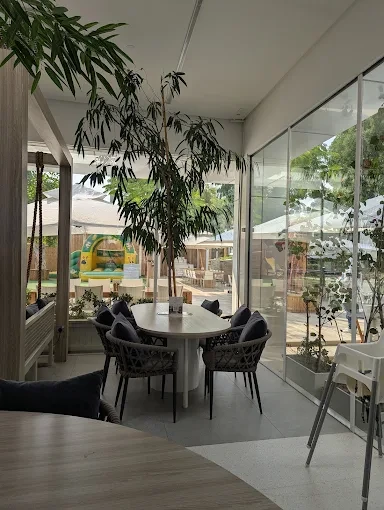 Dining area at The Farm Restaurant Al Barari, Dubai with greenery.