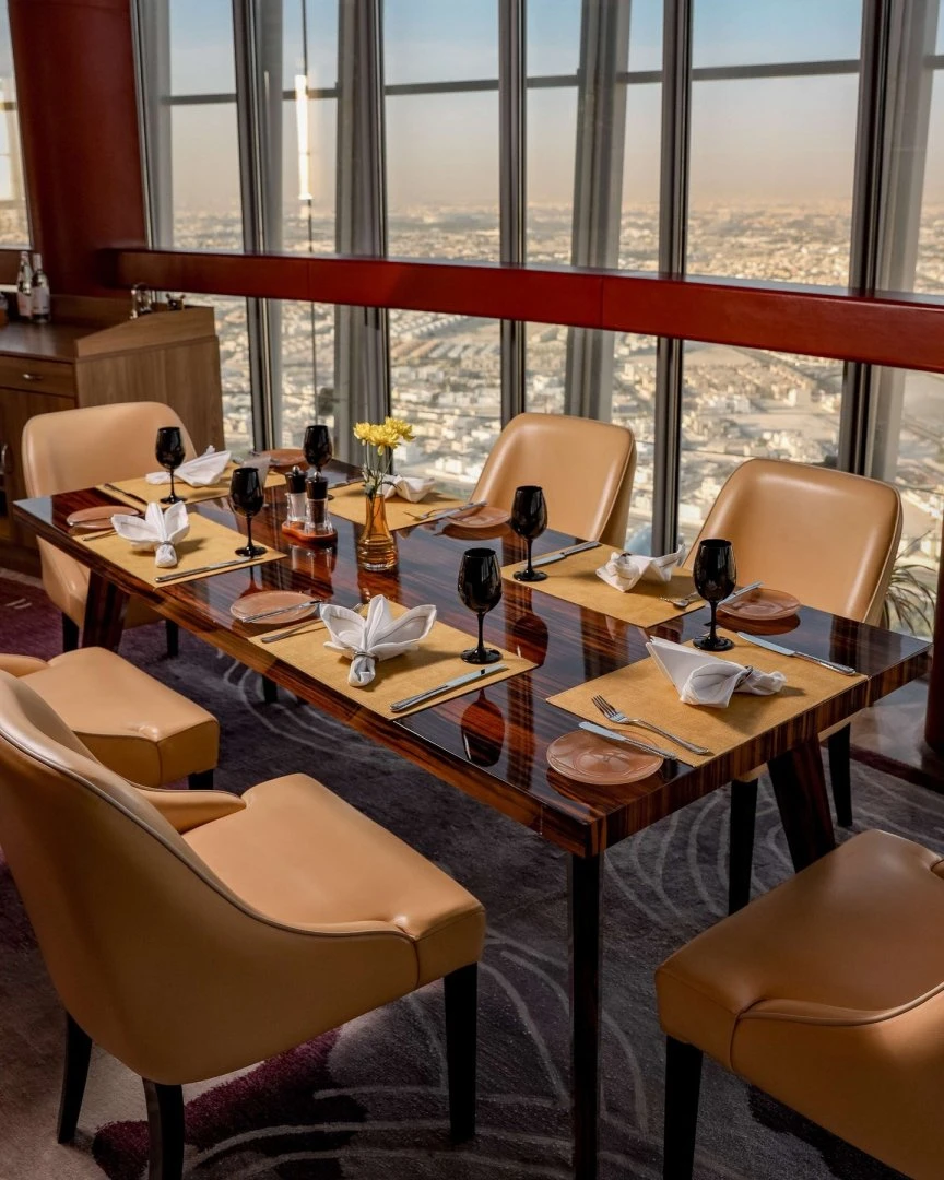 Elegant dining setup at Three Sixty Restaurant 360 Doha with city view.