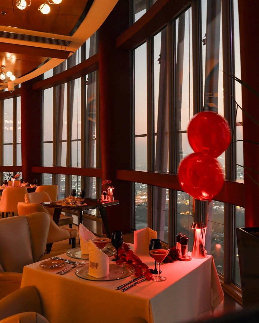 Elegant dining setup at Three Sixty Restaurant 360 Doha during sunset.