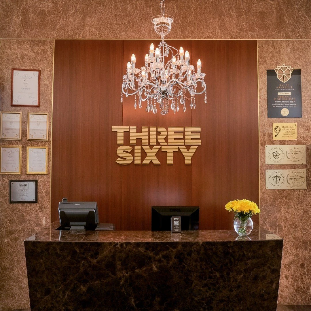 Three Sixty Restaurant reception with chandelier and awards, Doha.