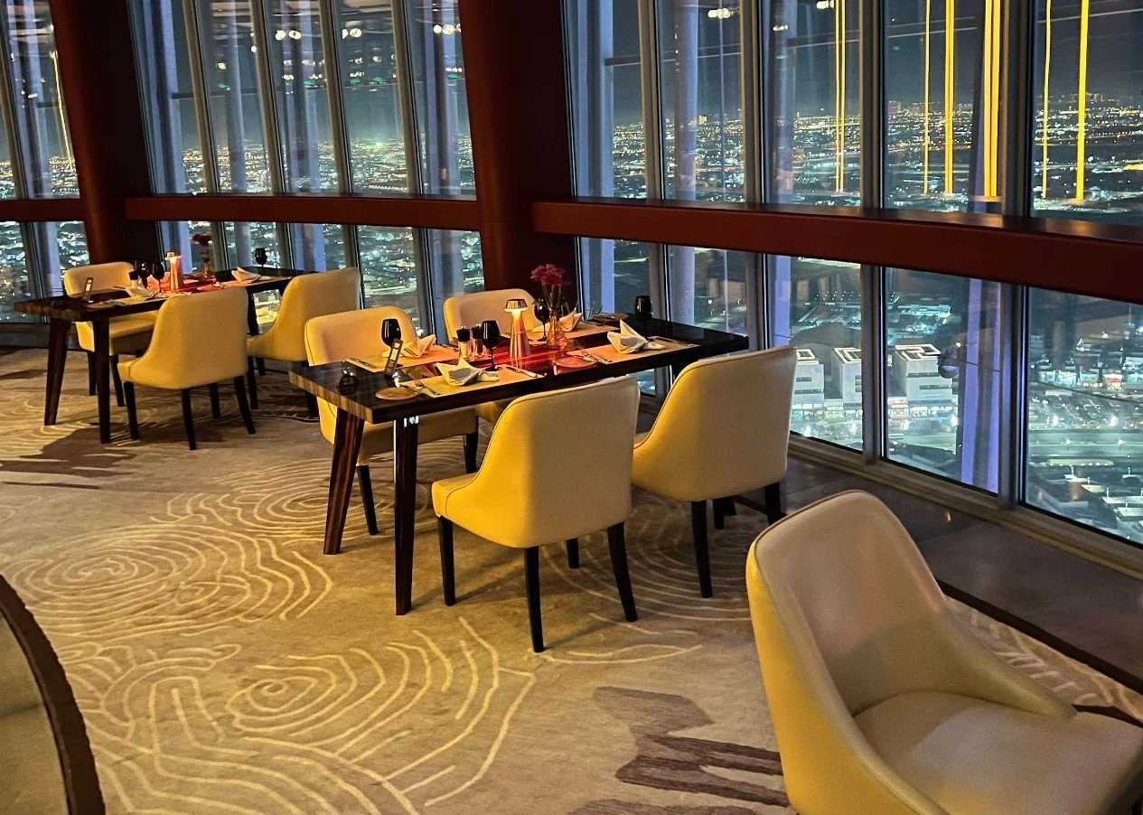 Luxurious dining tables overlooking Doha skyline at night, Three Sixty.