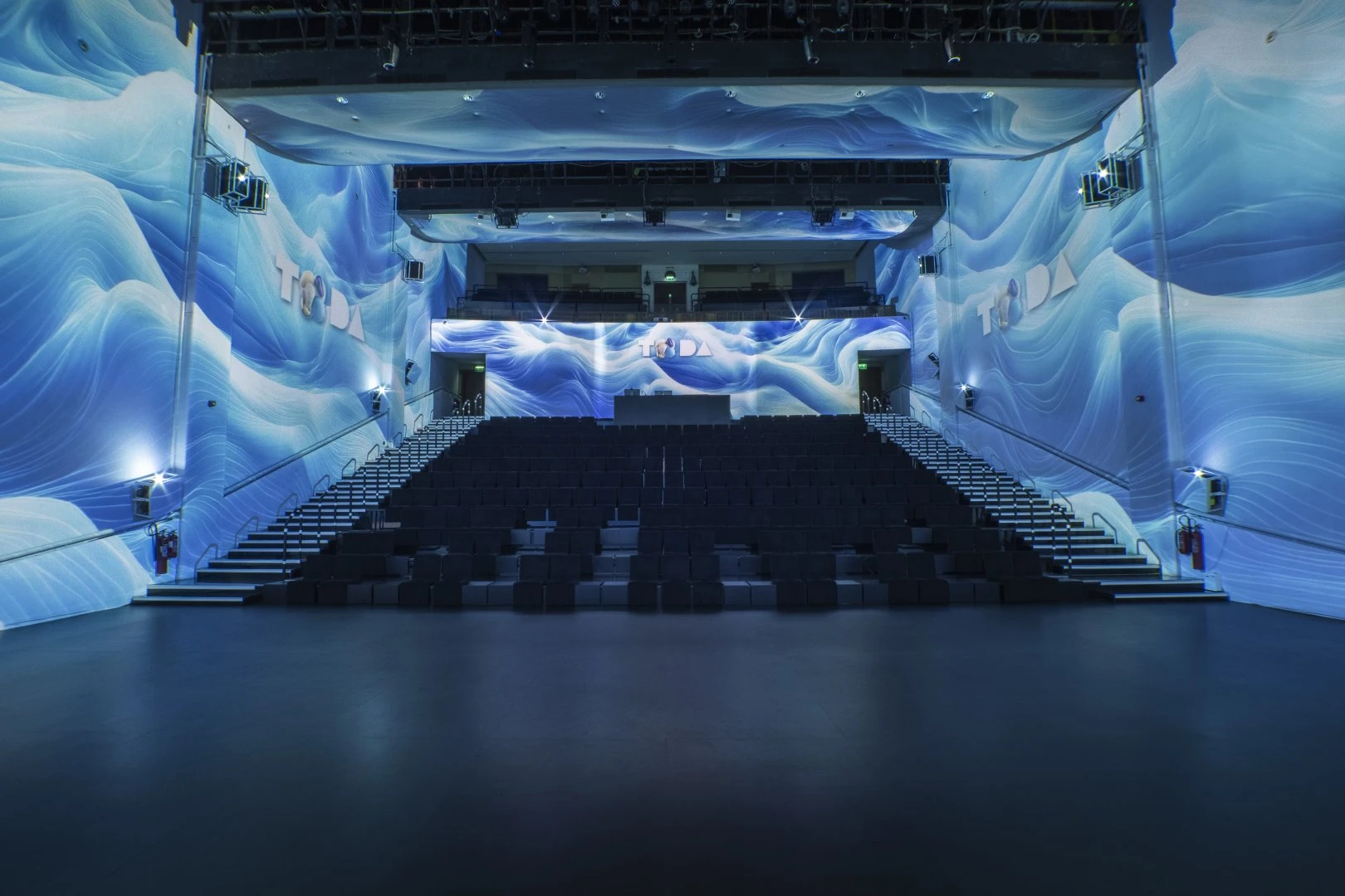 TODA Dubai auditorium with immersive blue wave visuals