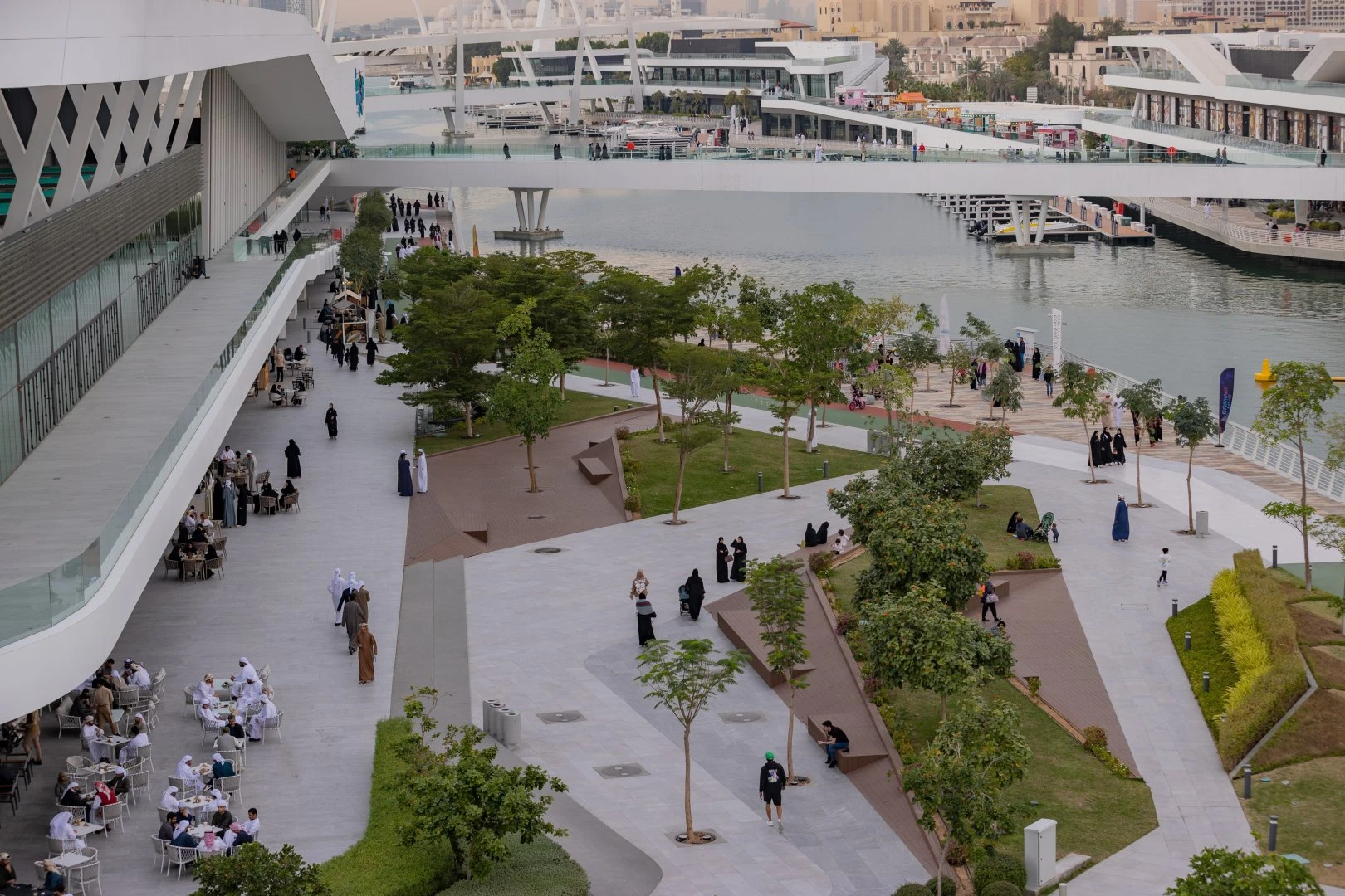 Al Qana promenade with people walking and dining, Abu Dhabi.