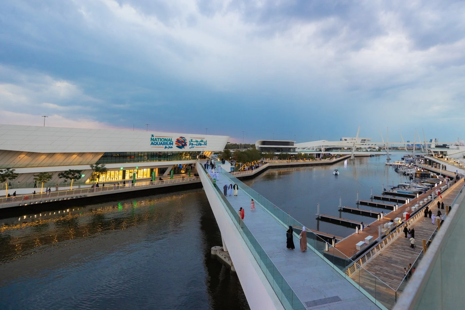 Al Qana waterfront with National Aquarium, Abu Dhabi, at dusk.